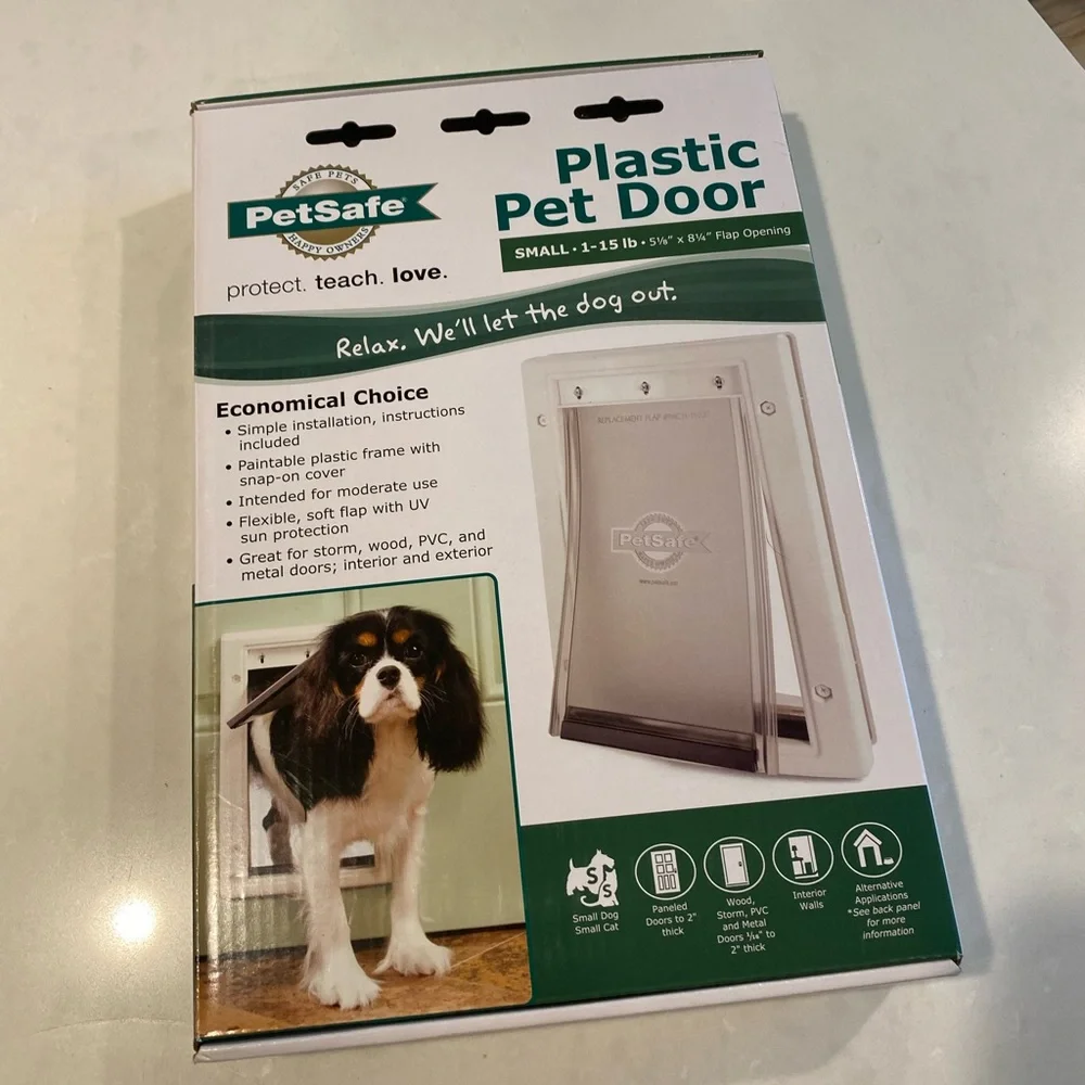 Pet safe small doggie door never used!!! Brand new box is sealed